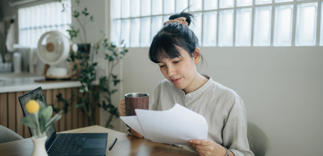 Woman reviewing personal loan documents at home office
