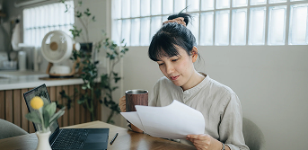 Woman reviewing personal loan documents at home office