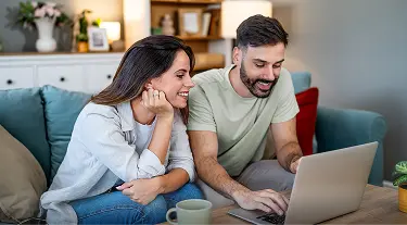 Couple on laptop browsing LendingTree for home refinance loan