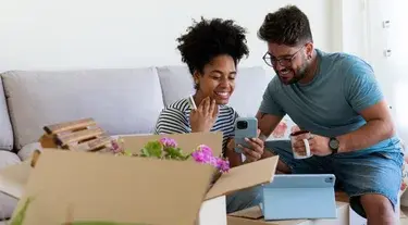 Couple smiling while checking woman's phone