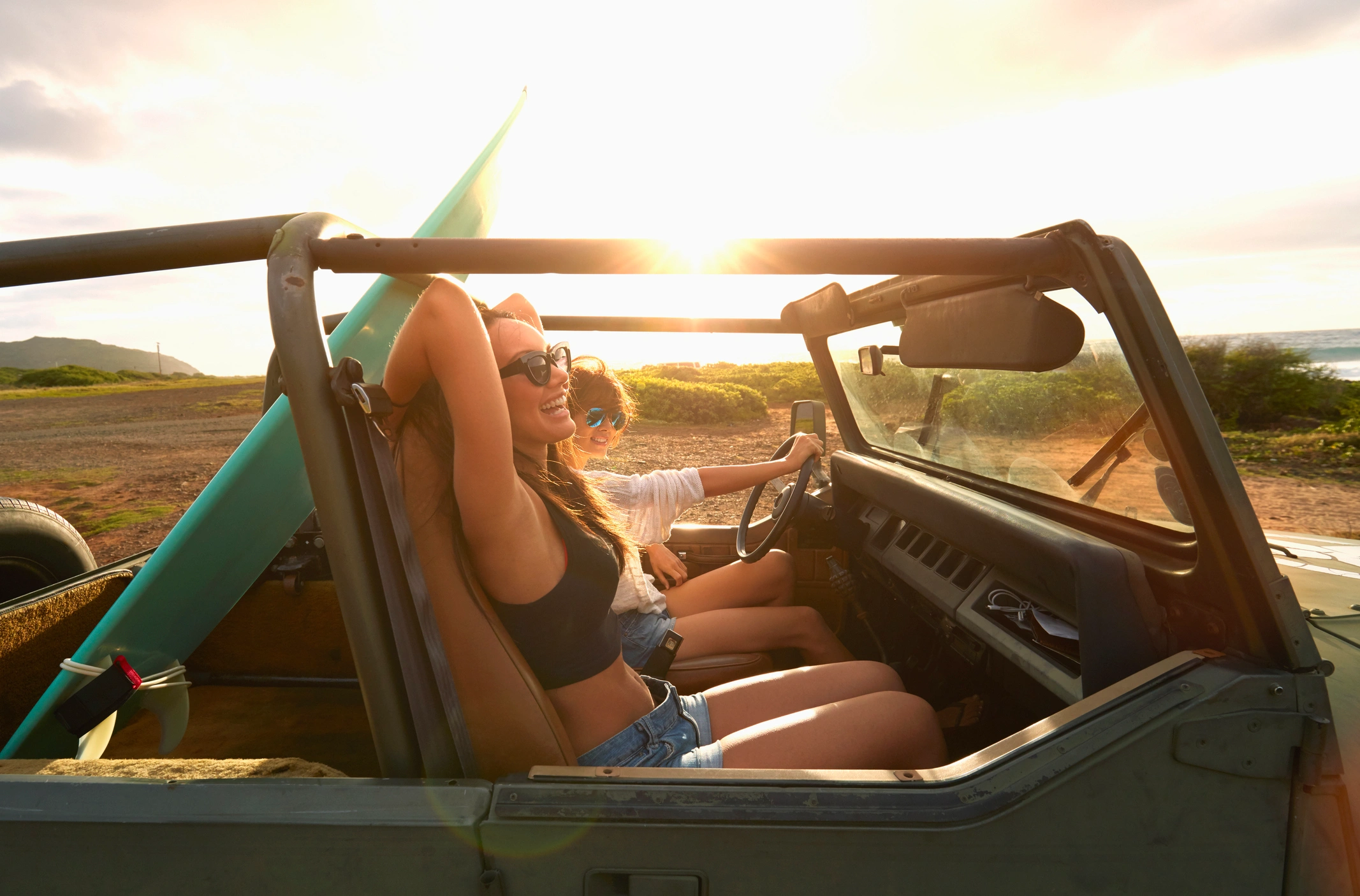 Two people drive around in a Jeep.