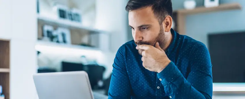 man looking intently at laptop